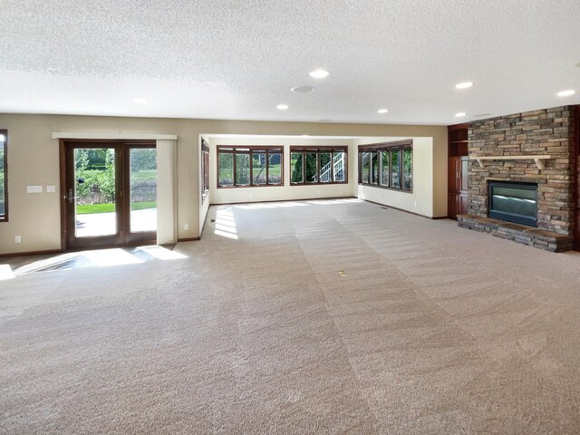 2464 Tournament Players Cir N, Blaine, MN 55449 - unfurnished living room with carpet, a textured ceiling, recessed lighting, a fireplace, and baseboards