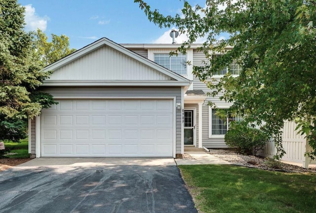 traditional home with an attached garage and driveway