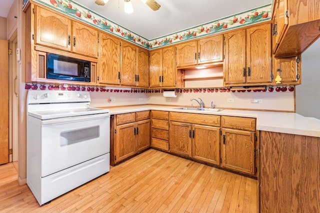 kitchen with a sink, light wood-type flooring, white range with electric stovetop, built in microwave, and brown cabinetry