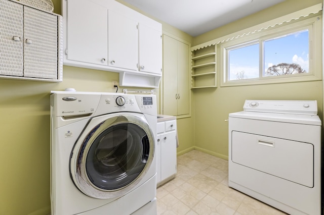 washroom with cabinet space, baseboards, and independent washer and dryer