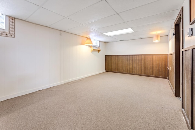 below grade area with a drop ceiling and carpet