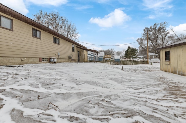 snowy yard with fence