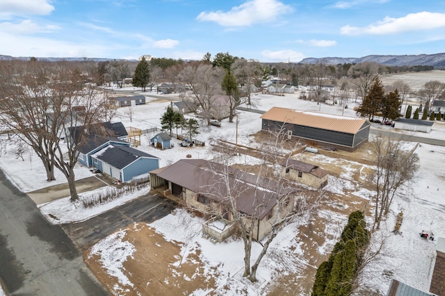 snowy aerial view featuring a mountain view