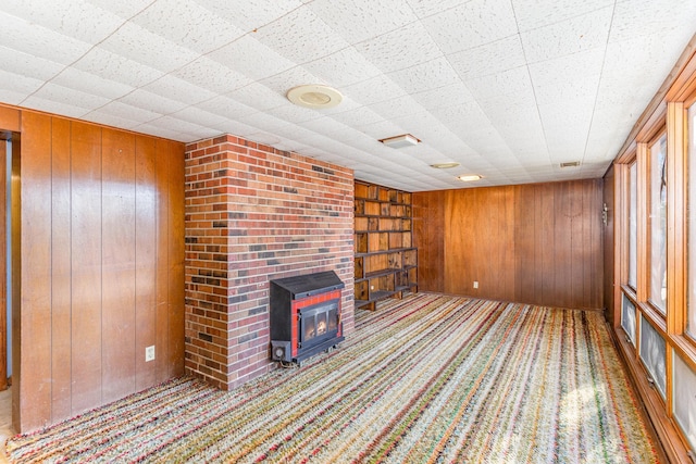 13197 132nd St W, Apple Valley, MN 55124 - unfurnished living room with wooden walls, carpet, a fireplace, and built in features