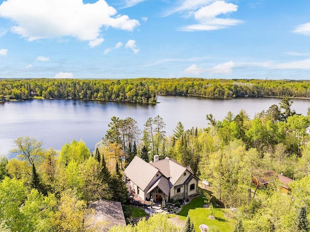 birds eye view of property with a water view and a view of trees