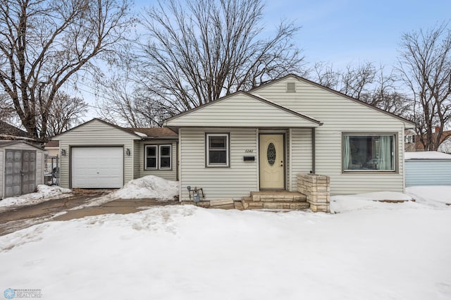 view of front of property with a storage shed, an attached garage, and an outdoor structure