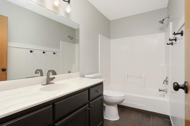 bathroom with toilet, tile patterned flooring, shower / tub combination, and vanity