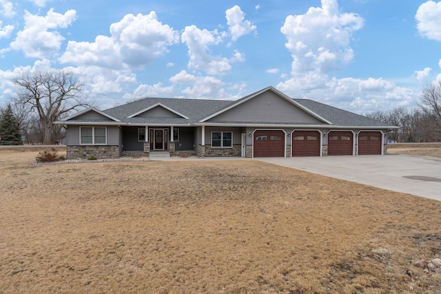 view of front of home with a garage, stone siding, a porch, and concrete driveway