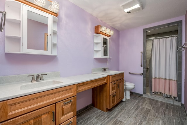 bathroom with double vanity, visible vents, toilet, and a sink