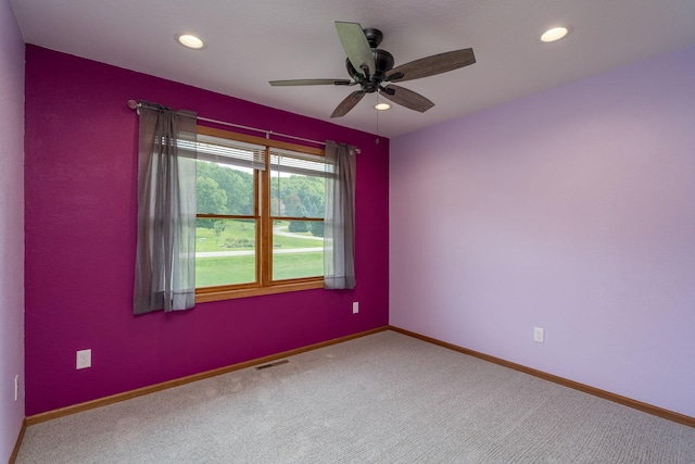 carpeted empty room with recessed lighting, visible vents, and baseboards