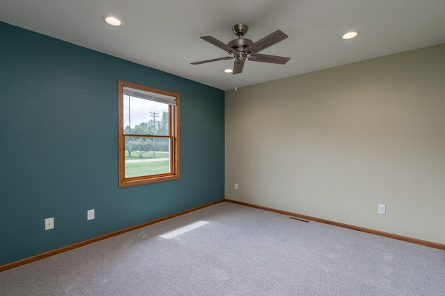 unfurnished room with recessed lighting, carpet flooring, visible vents, and baseboards