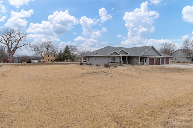 rear view of property featuring a garage and a porch