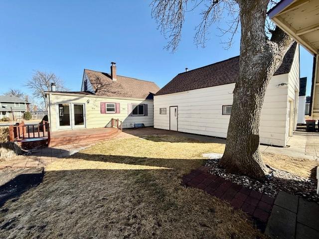 rear view of property with a patio area and a chimney