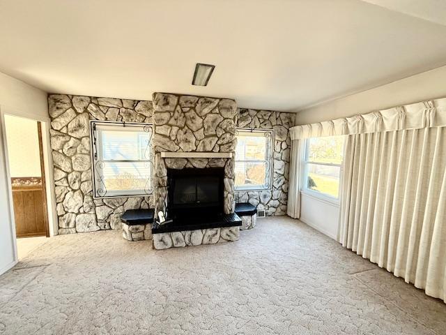 carpeted living area with a fireplace