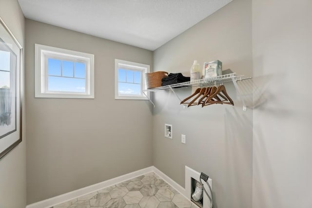 washroom with light tile patterned floors, laundry area, hookup for a washing machine, and baseboards