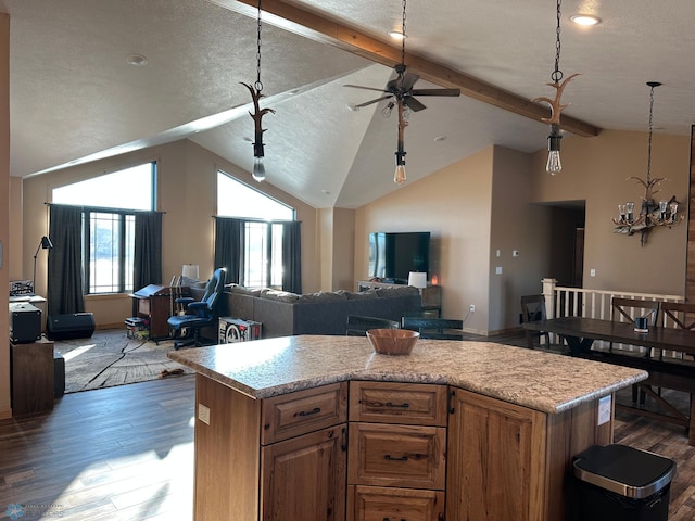 kitchen with dark wood-type flooring, open floor plan, and vaulted ceiling with beams