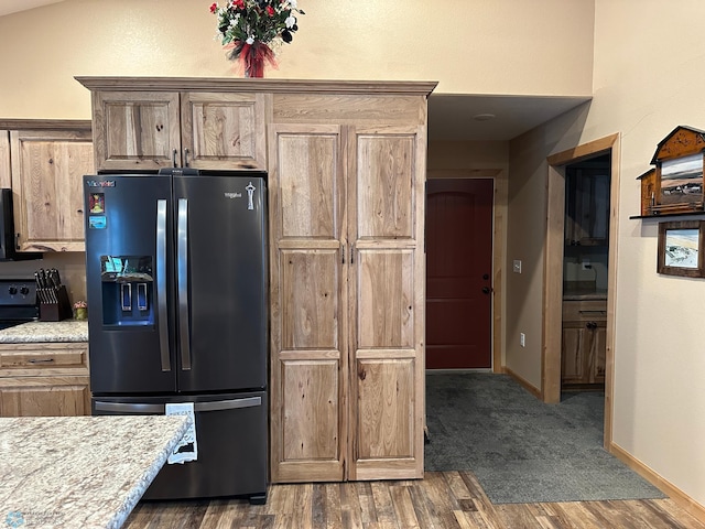 kitchen with dark wood finished floors, electric range oven, black fridge with ice dispenser, and baseboards