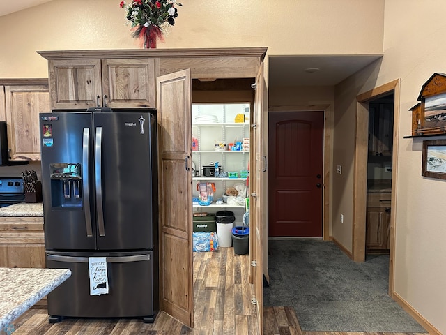 kitchen with baseboards, range with electric cooktop, dark wood-type flooring, and stainless steel fridge with ice dispenser