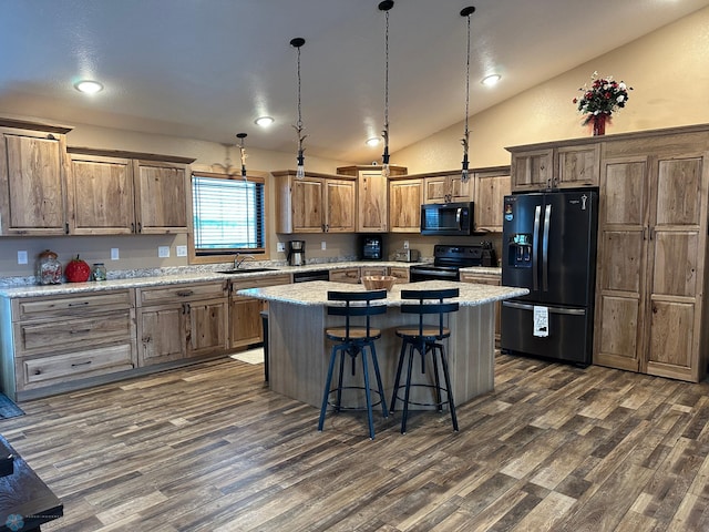 kitchen with lofted ceiling, a sink, a center island, black appliances, and dark wood finished floors