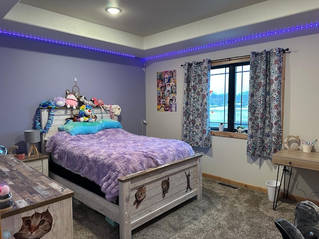 bedroom with carpet flooring, visible vents, and baseboards