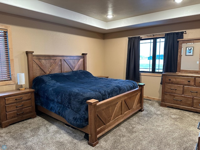 bedroom with light carpet and baseboards