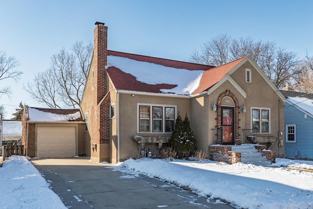 view of front of home featuring stucco siding, an outbuilding, and a chimney