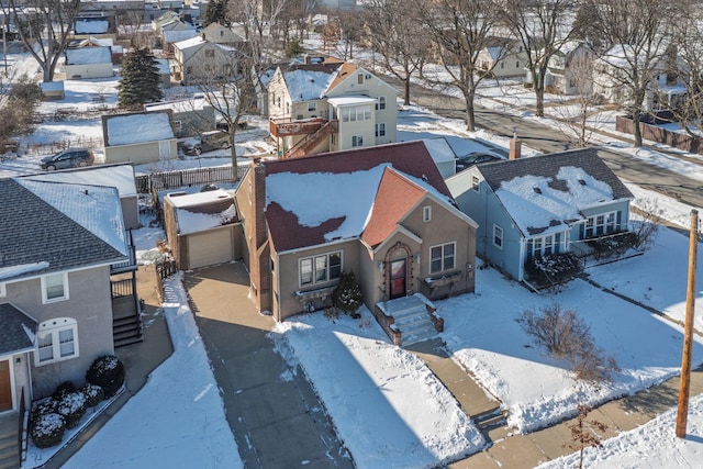 snowy aerial view featuring a residential view