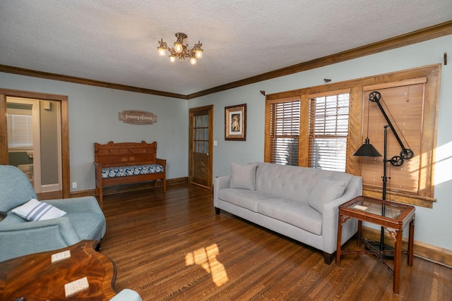 living room with a chandelier, a textured ceiling, baseboards, and wood finished floors