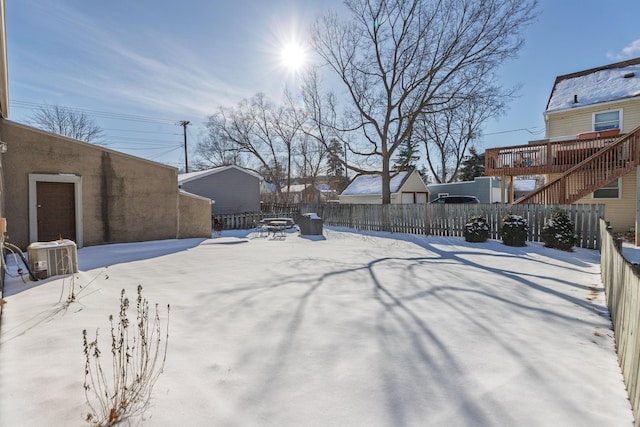 snowy yard with an outdoor fire pit and fence