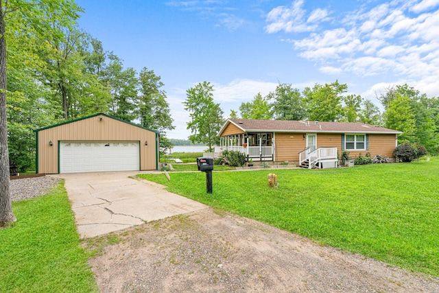 view of front of property featuring a garage, covered porch, and a front yard