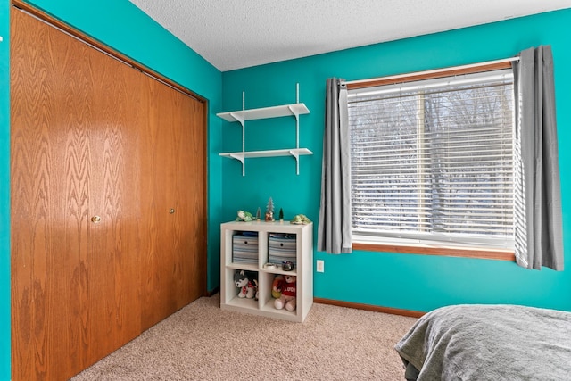 bedroom with light carpet, a closet, and a textured ceiling