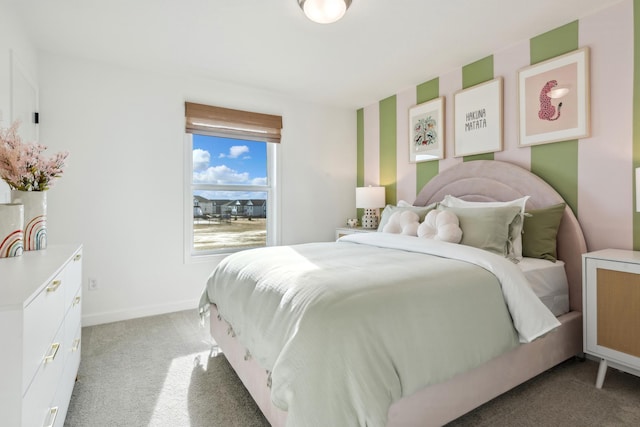 bedroom featuring light carpet and baseboards