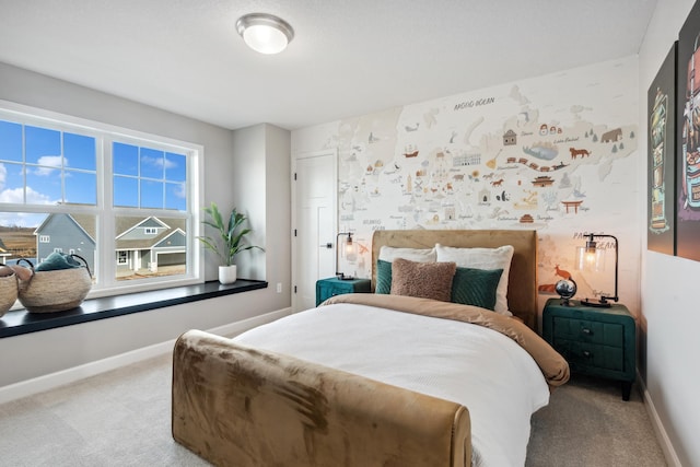 bedroom featuring light carpet, baseboards, and wallpapered walls