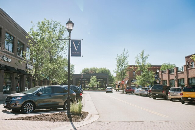 view of road featuring sidewalks, curbs, and street lights