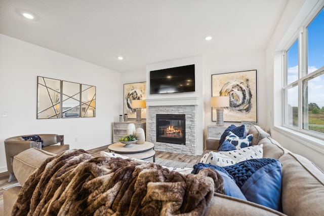 living room featuring a fireplace, recessed lighting, wood finished floors, and baseboards