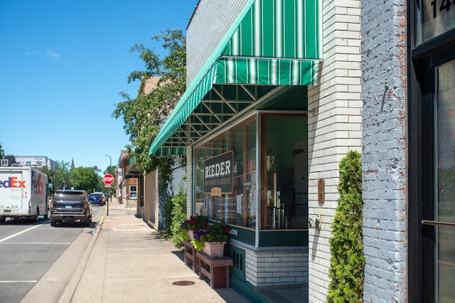 doorway to property featuring brick siding