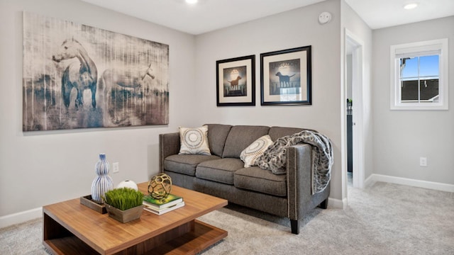 living area with recessed lighting, light carpet, and baseboards