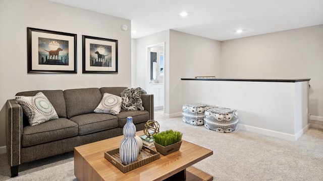 living area with baseboards, light colored carpet, and recessed lighting