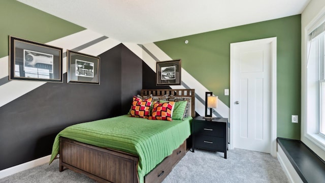 bedroom with light carpet and baseboards