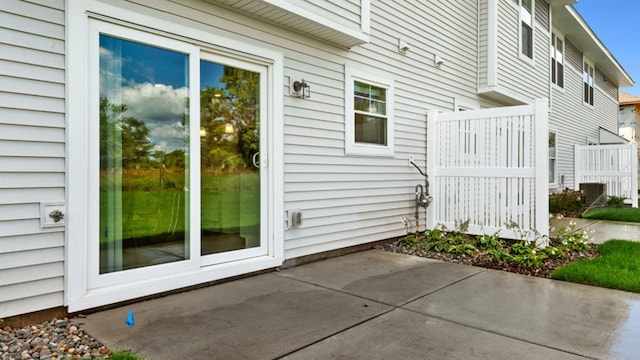 view of side of property with central air condition unit and a patio