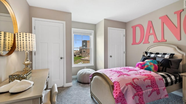 bedroom with baseboards and carpet