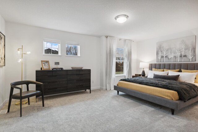 bedroom with light carpet and baseboards