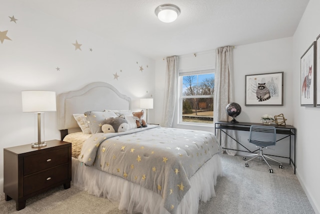 bedroom featuring light colored carpet and baseboards