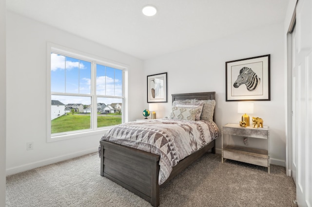 bedroom featuring carpet and baseboards