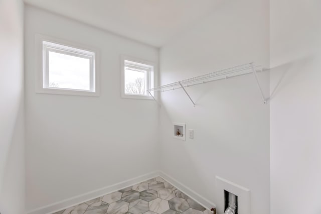 clothes washing area featuring hookup for a washing machine, laundry area, and baseboards