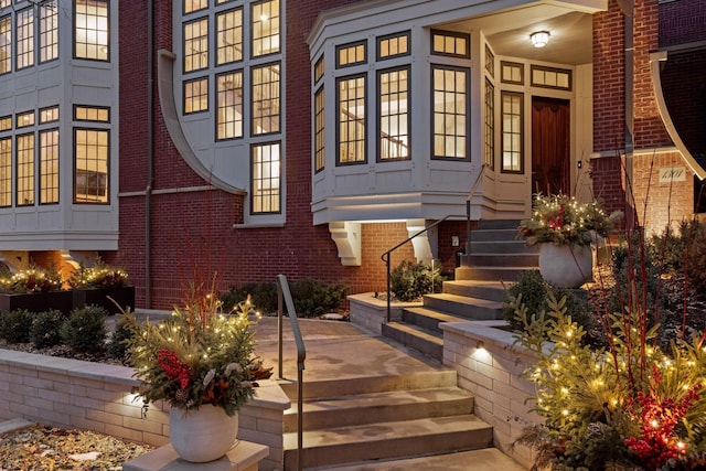 entrance to property featuring brick siding