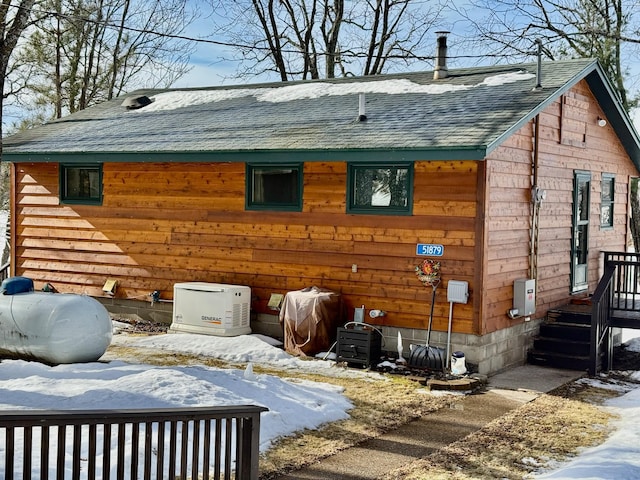 view of property exterior featuring a shingled roof