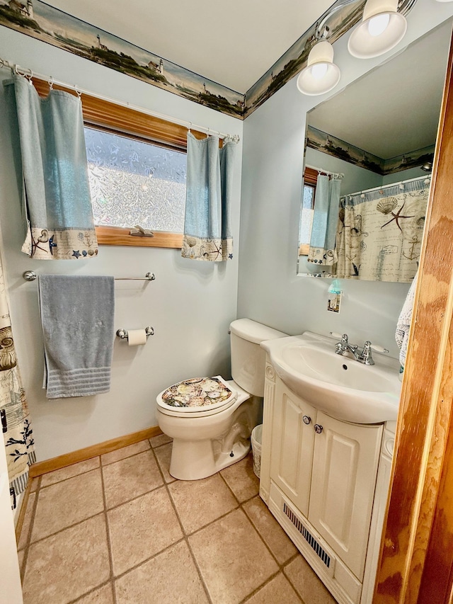 bathroom with vanity, tile patterned floors, and toilet