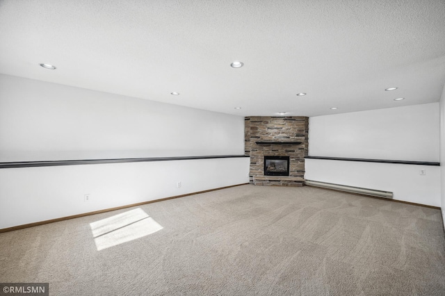 unfurnished living room with a textured ceiling, a baseboard radiator, light carpet, a fireplace, and baseboards