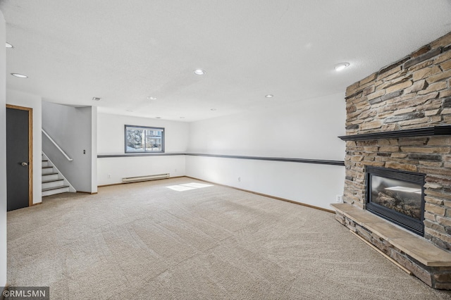 unfurnished living room featuring a baseboard heating unit, carpet floors, a fireplace, baseboards, and stairs